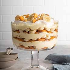 Layered banana pudding in a glass footed bowl
