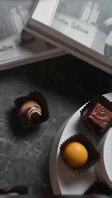 Three Dallmann Chocolate Bonbons On A Plate