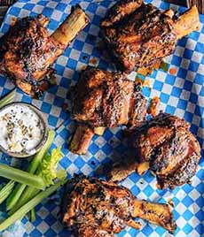 Pig Wings Buffalo-style with celery sticks and blue cheese dressing.
