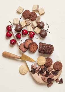 A Cheese Board With Chocolate Cherry Goat Cheese & Cookies