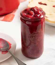 A jar of homemade cherry pie filling