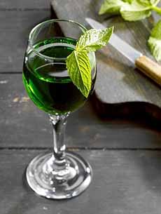 A liqueur glass of creme de menthe.