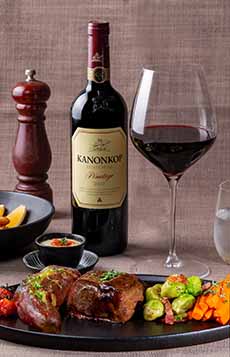 A Glass Of Pinotage Red Wine With Grilled Venison and Mixed Vegetables
