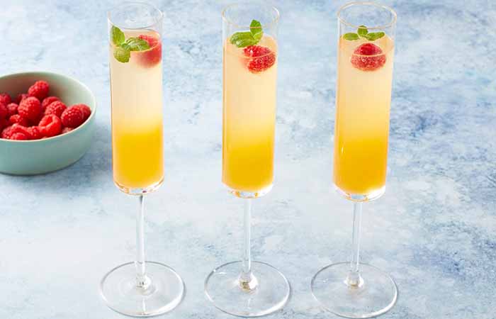 Bellini Cocktail With Raspberry Garnish