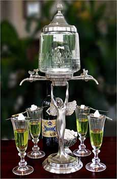 An Absinthe Fountain, which holds the spirit with spouts for dripping it into glasses.