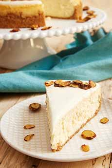 A slice of Amaretto Cheesecake, topped with almonds