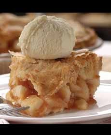 A slice of Apple Pie A La Mode, topped with a scoop of vanilla ice cream
