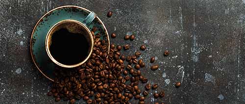 Cup Of Black Coffee And Coffee Beans