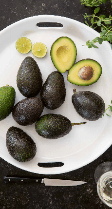 Whole & Halved Avocados On A Platter