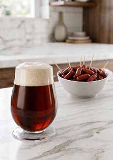 Bock Beer With A Bowl Of  Sausage Links