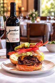 A bottle of Bedrock Zinfandel with a deluxe burger.