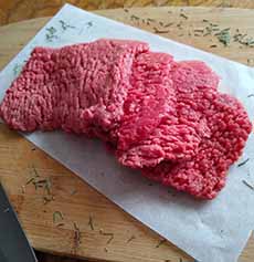 Raw Cube Steak On A Cutting Board
