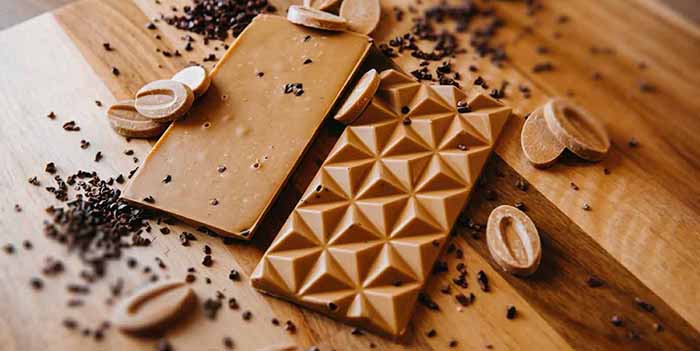 A blonde chocolate bar with cacao nibs.