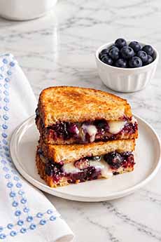 A grilled cheese sandwich with blueberry preserves.
