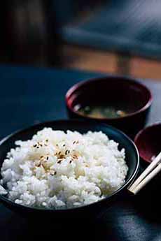 A Bowl Of Japanese Rice With Chopsticks