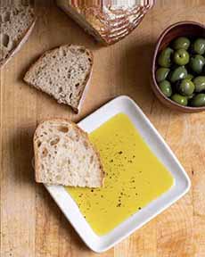 A Dish Of Dipping Oil With Sourdough Bread