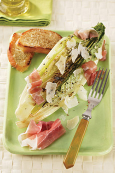 Hearts of romaine are cut in half, not torn, to create a different approach to Caesar Salad