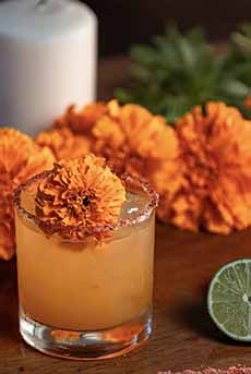 A Mezcal Cocktail With Fresh Geranium Flower Garnish