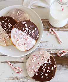 A plate of black and white cookies decorated with chopped candy canes.