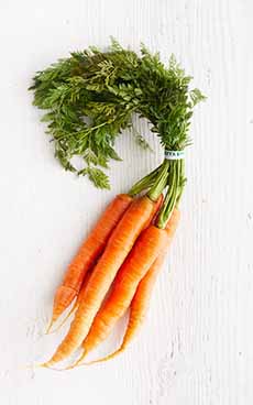 A Bunch Of Carrots With Their Tops