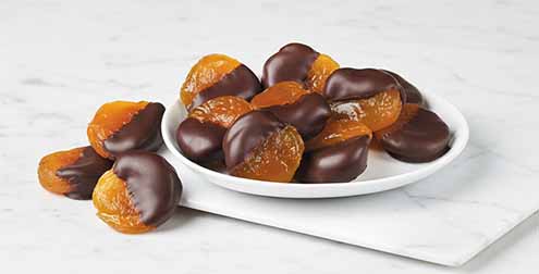 A Plate Of Chocolate Dipped Apricots