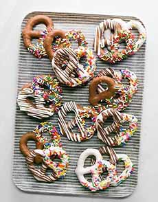 A tray of chocolate-covered pretzels with milk and white chocolate.