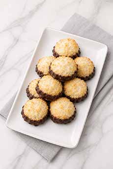 A Plate Of Chocolate Dipped Macaroons