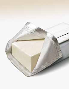 Block of cream cheese in foil wrapper