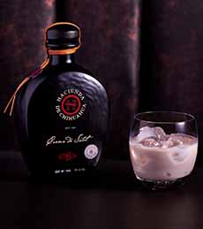 A bottle and glass of Crema de Sotol