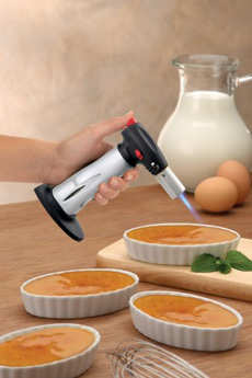 A Kitchen Torch Torching The Sugar Top Of Creme Brulee