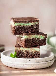 A plate with three creme de menthe brownies.