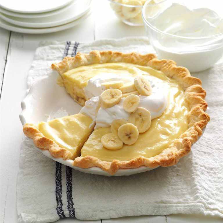 A Double Banana Cream Pie Topped With Whipped Cream & Sliced Bananas