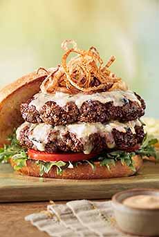 A double cheeseburger with onion rings.