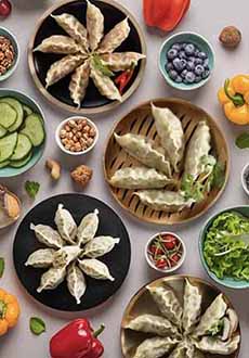 A table set with 4 varieties of Korean dumplings