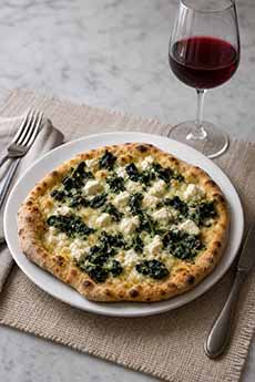 Feta-Spinach Pizza With A Glass Of Red Wine