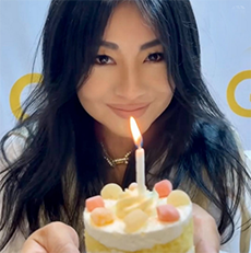Mochi Gummies decorating a birthday cupcake with a candle