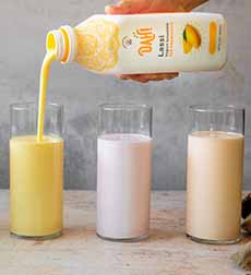 Three Flavors Of Dah Lassi Pouring From The Bottle