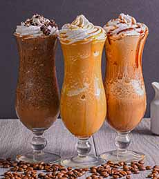 Three French-style parfaits. They are blended frozen desserts, not layered ice cream.