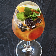 A Glass Of Iced Tea With A Fresh Fruit Garnish