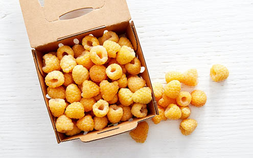 A box of golden raspberries