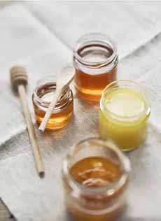 4 Varieties Of Honey In Open Jars