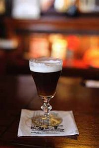 A glass of Irish coffee in the traditional stemmed glass