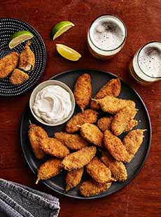 A Plate Of Jalapeno Poppers With Dip
