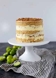 A Key lime pie layer cake on a pedastel.