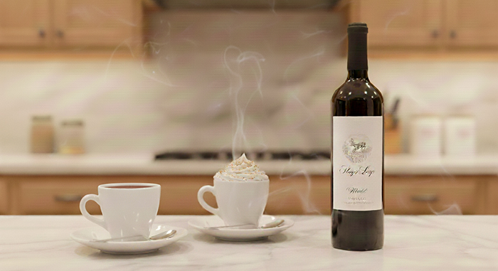 Two cups of hot chocolate with a bottle of Merlot