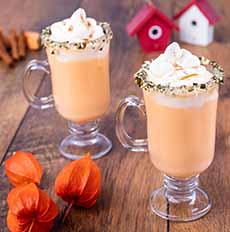 Two stemmed, handled glasses of Mozart Pumpkin Spice Hot Chocolate Punch