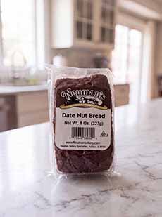 A loaf of Neuman's Date Nut Bread on a kitchen counter.
