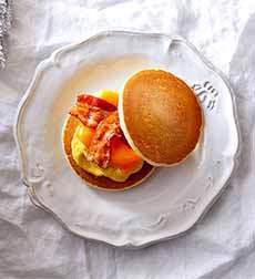 Breakfast Pancake Sandwich: Two pancakes with bacon and eggs.