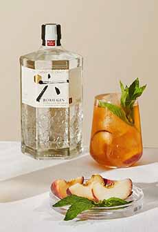 A Bottle Of Gin & A Glass Of Peach Gin Tea