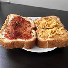 Peanut butter and jelly sandwich with Corn Flakes